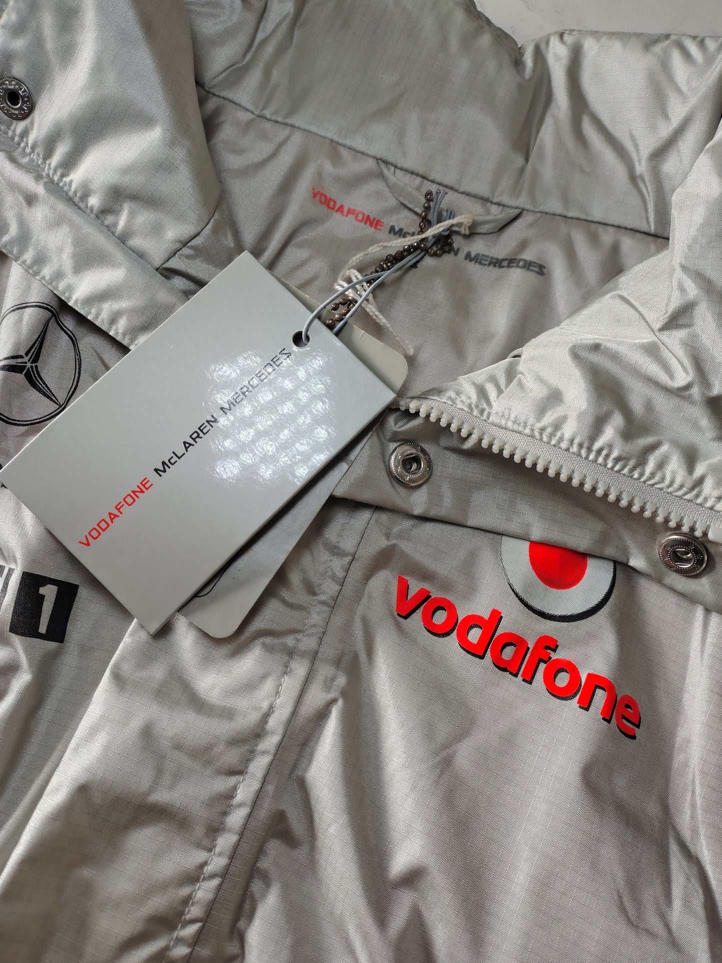 Official Vodafone McLaren Mercedes silver team mens rain jacket BNWT Lewis Hamilton